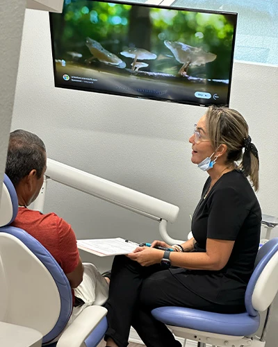 Dentist in Tampa, FL consulting with a patient in a modern dental office setting