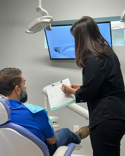 Patient consultation for dentures in Tampa, FL at a modern dental office